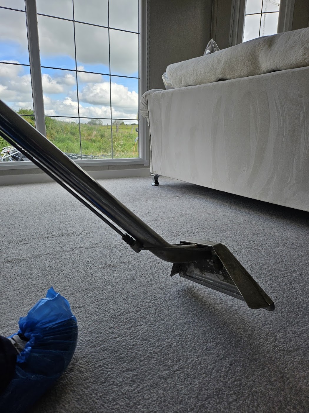 Extraction wand on a clean bedroom carpet
